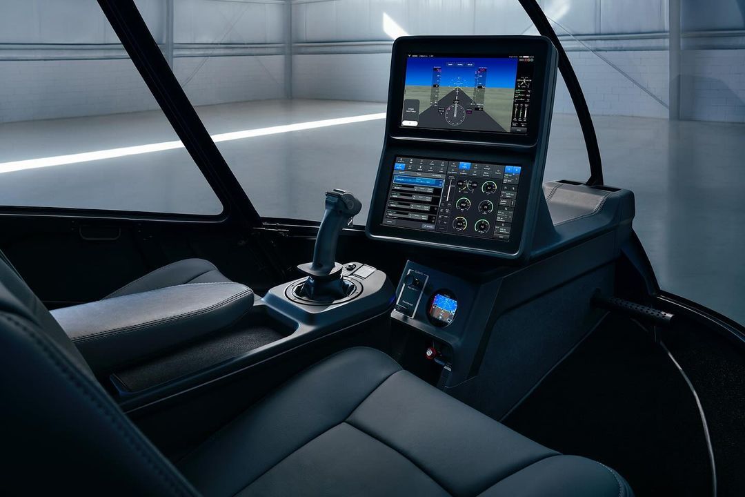Interior view of a futuristic aircraft cockpit with screens displaying flight information, showcasing advanced aviation technology.
