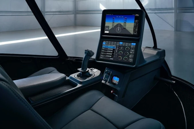Interior view of a futuristic aircraft cockpit with screens displaying flight information, showcasing advanced aviation technology.