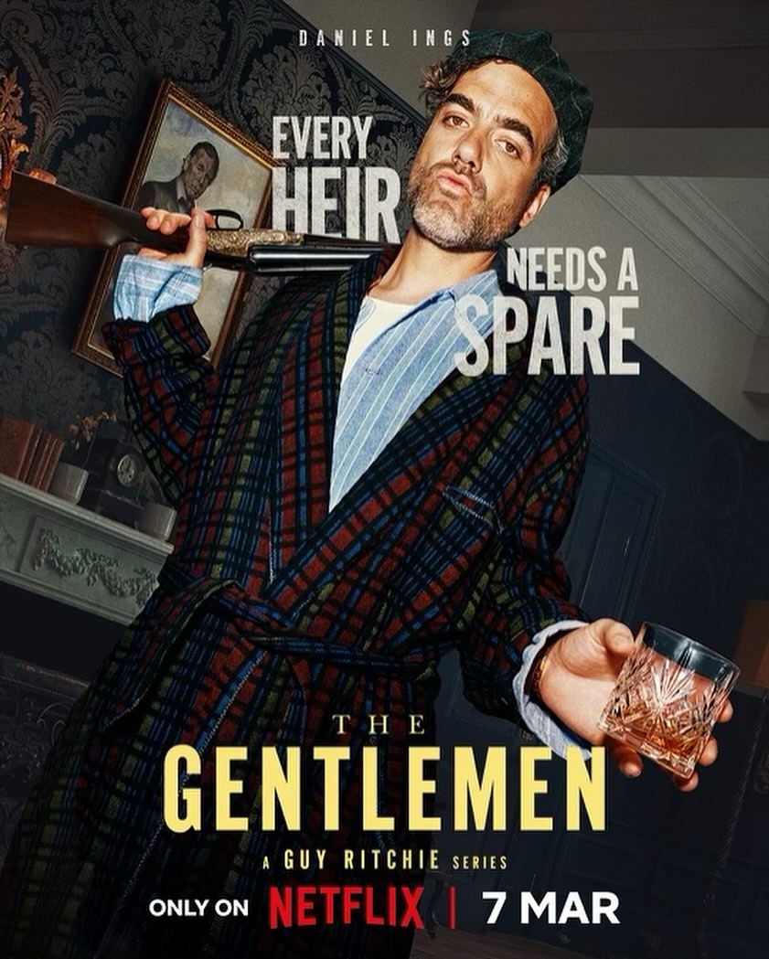 Promotional poster for 'The Gentlemen' on Netflix. A man holds a shotgun and a glass of whiskey against an indoor backdrop.