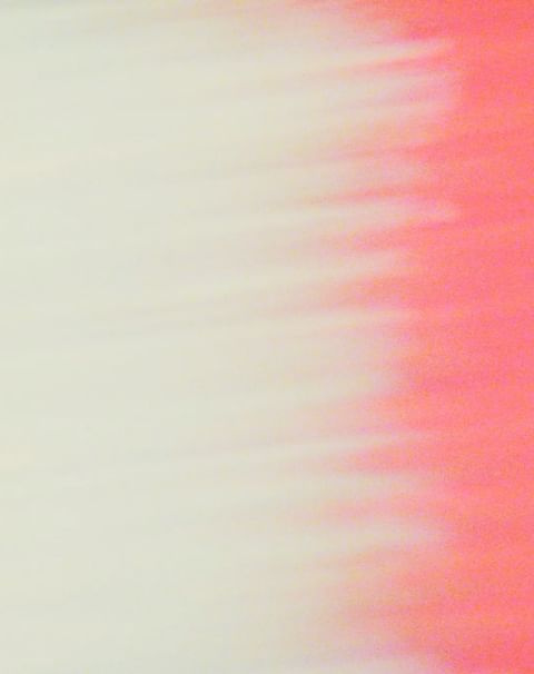 Blurred abstract background with blended shades of cream and coral creating a soft, dreamy effect, suitable for backgrounds.
