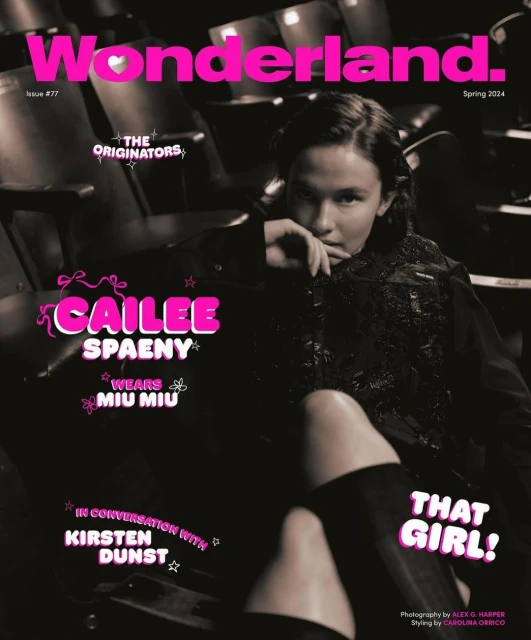 Wonderland magazine cover featuring Cailee Spaeny in a dark setting. Spaeny wears Miu Miu clothing; pink magazine text and a theatre are visible.