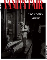 Magazine cover featuring a person in a protective hazmat suit and gas mask spraying a storefront at night photographed by Alex Majoli