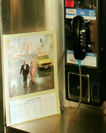 Calendar photo shows an elegantly dressed couple walking in the rain with a yellow car and buildings in the background, hanging next to a payphone.