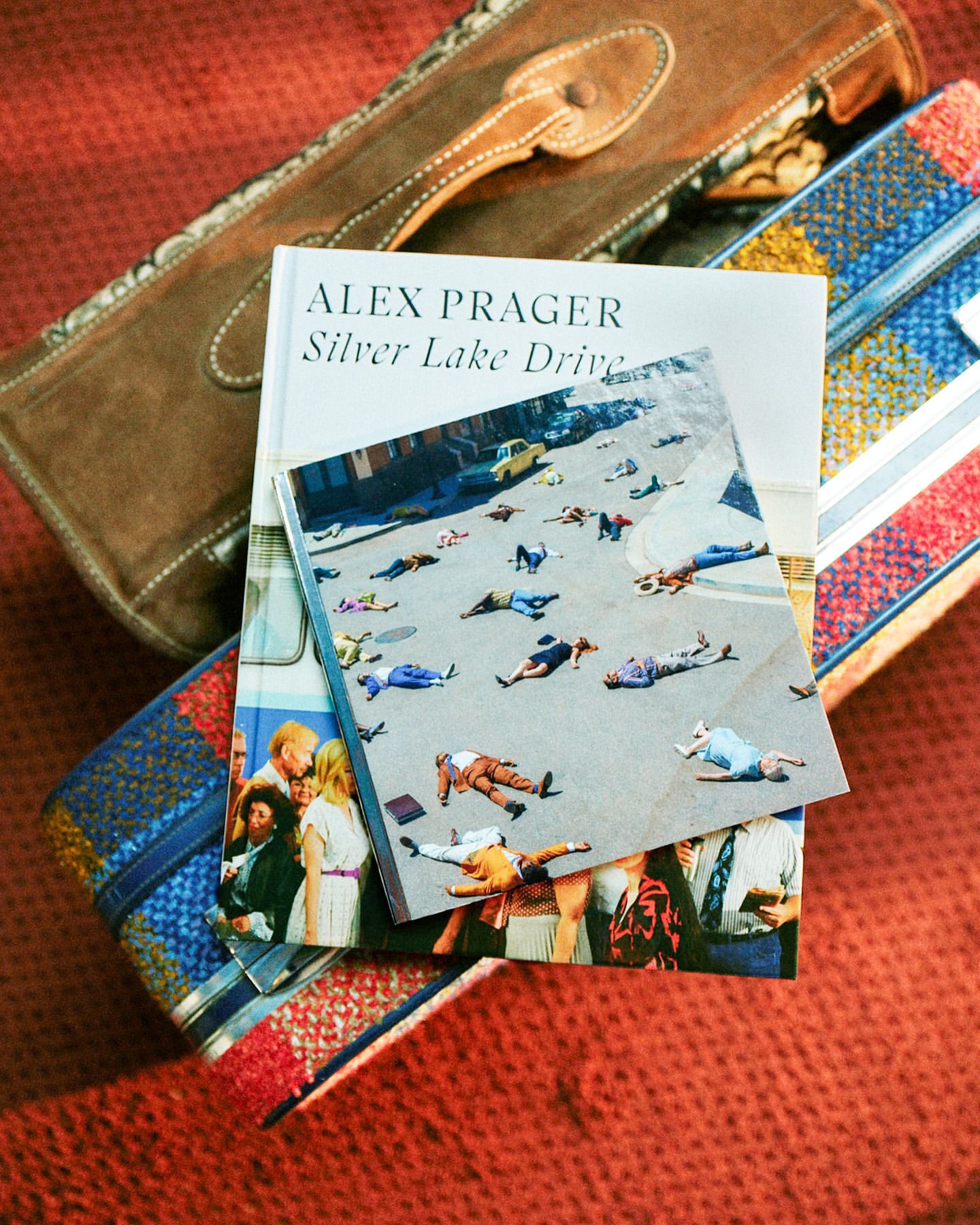 Alex Prager's 'Silver Lake Drive' book displayed with handbags, highlighting fashion photography and book design in a studio setting.