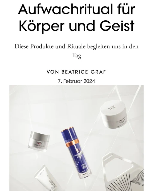 Still life of skincare products, including creams and serums, arranged on a glossy white surface with neutral lighting. Beauty concept.