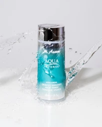 M. Asam Aqua Intense face tonic bottle centered against a white background with dynamic water splashes