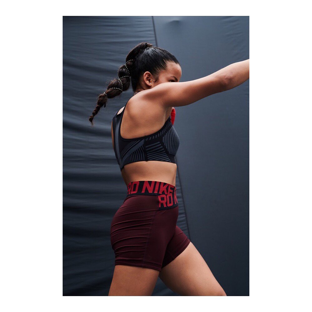 Athletic woman in workout attire strikes a dynamic pose against a textured grey background in a fitness-themed shot with bold typography.