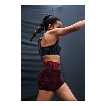 Athletic woman in workout attire strikes a dynamic pose against a textured grey background in a fitness-themed shot with bold typography.