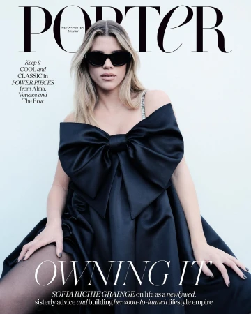 Magazine cover featuring Sofia Richie Grainge wearing a black off-the-shoulder gown with a large bow and black sunglasses against a white backdrop.