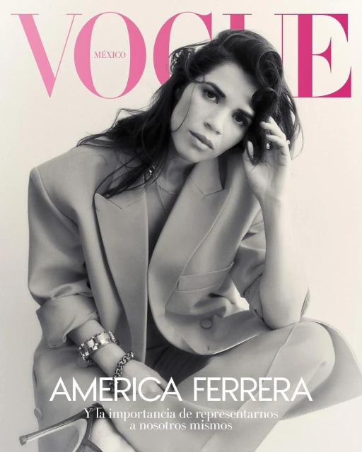 Vogue Mexico cover featuring America Ferrera in a tan blazer, bracelets, and peep-toe heels, posing in front of a light-pink logo background.