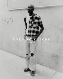 Black man wearing a plaid shirt and distressed jeans standing against a textured concrete wall with overlaid text