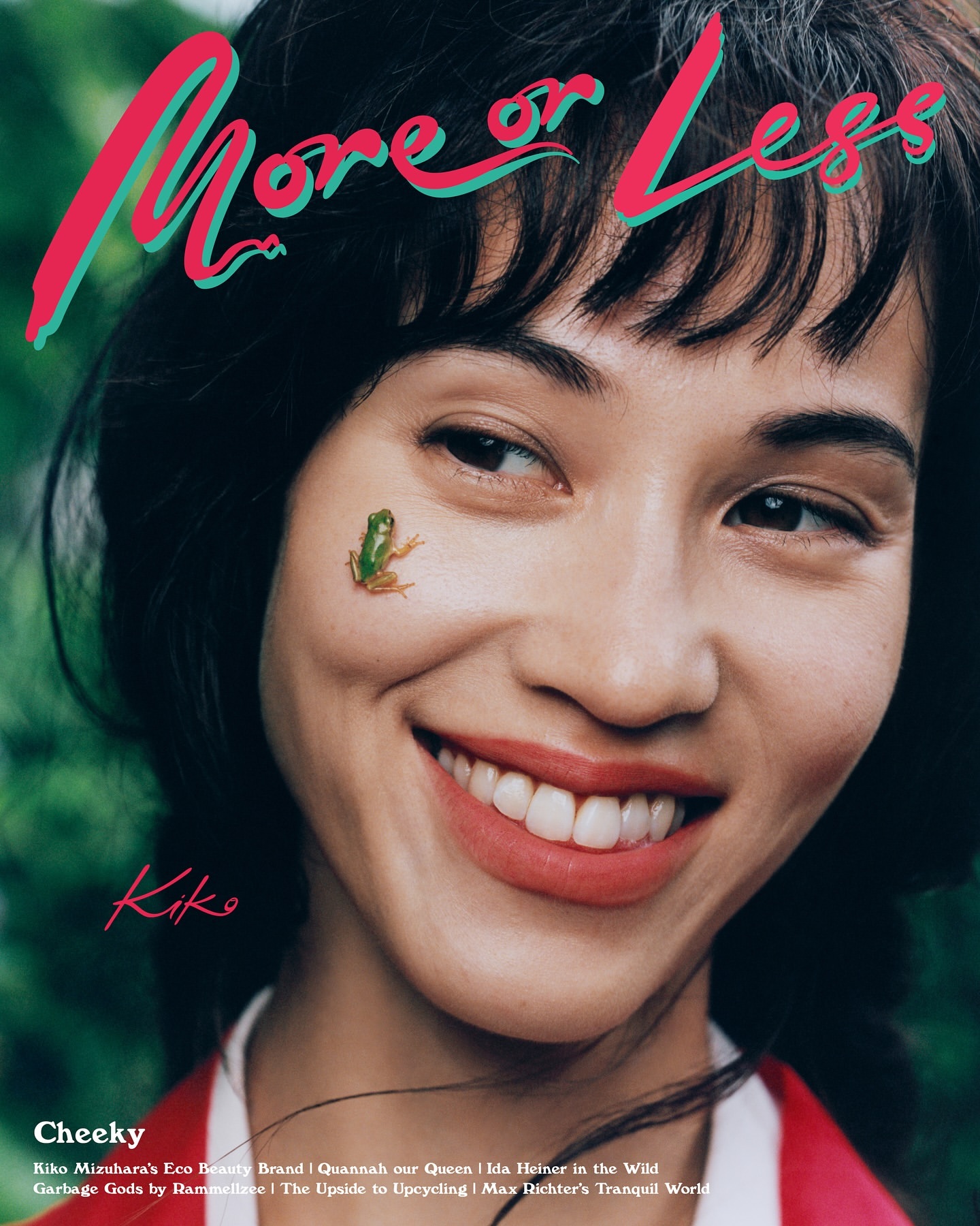 Close-up magazine cover of a smiling adult female with a green frog on her face, black hair, and pink and teal 'More or Less' title text.