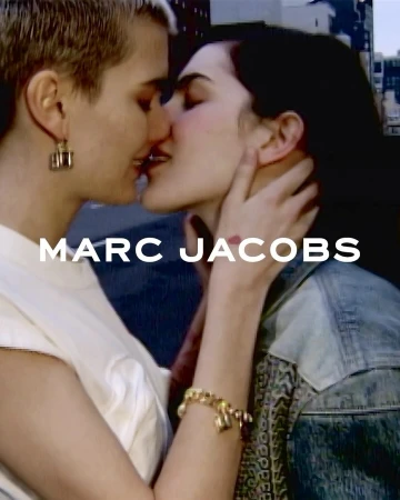 Two women kissing outdoors in New York captured in a close portrait by photographer Alexandra Leese with Marc Jacobs branding.