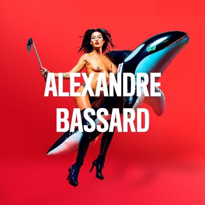 A nude woman in thigh-high boots is holding a riding crop and riding an inflatable orca against a solid red backdrop, with bold white text.