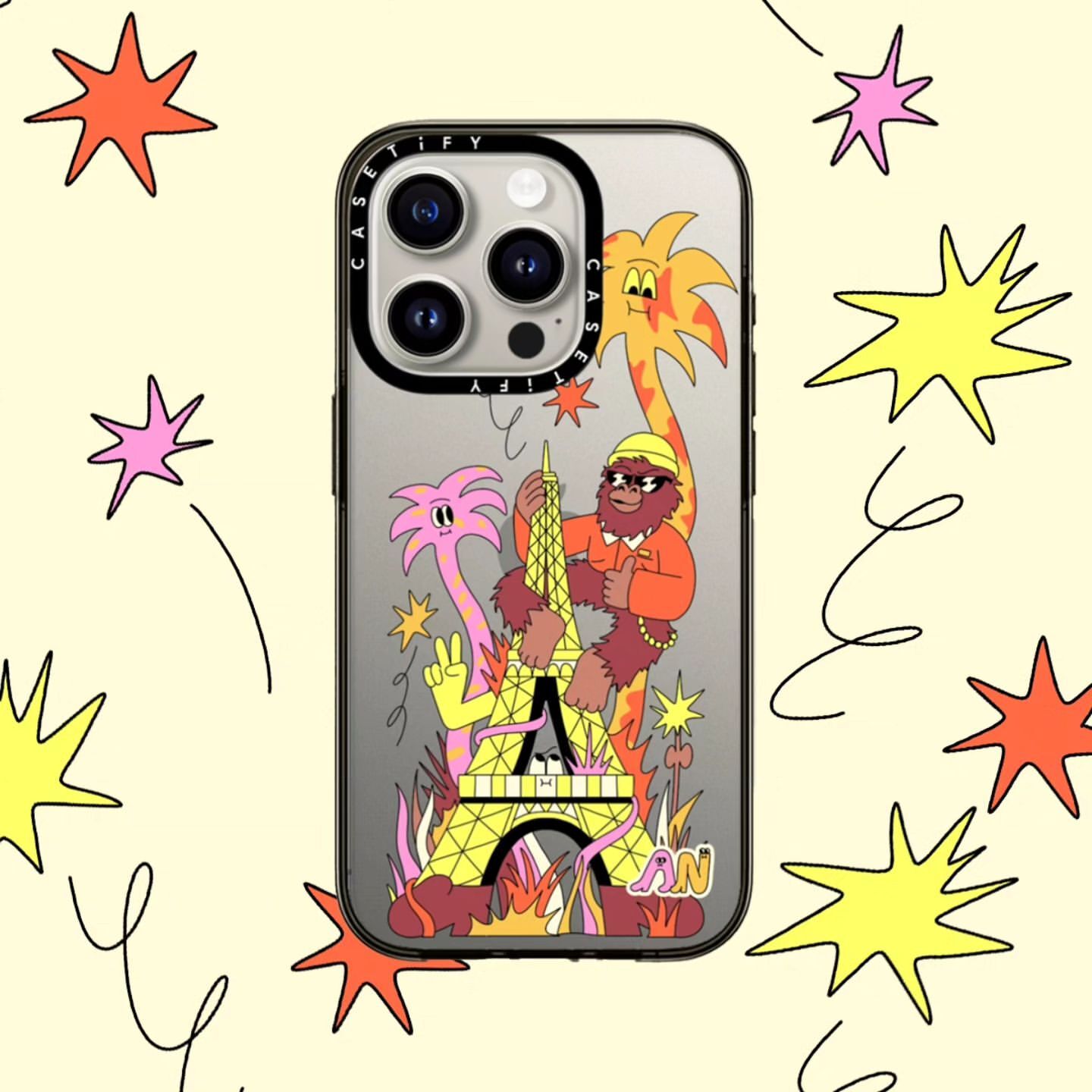 IPhone case featuring an illustration of the Eiffel Tower, a gorilla, and cartoon palm trees on a yellow background with star shapes.