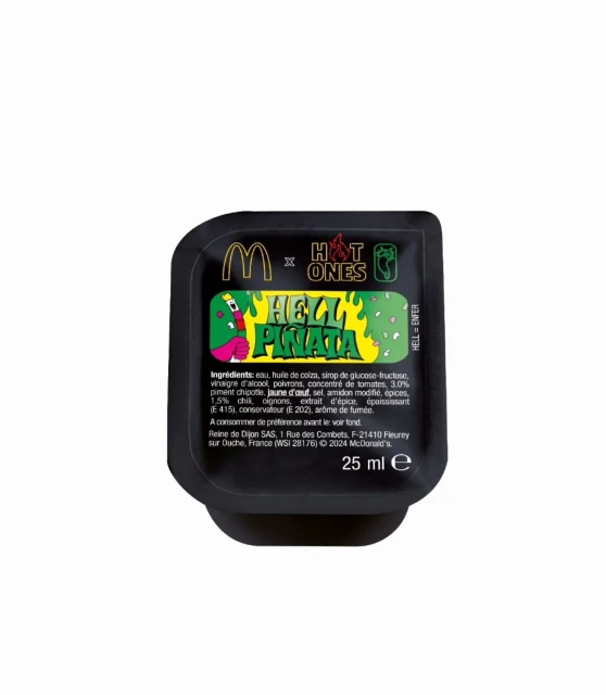 McDonald's Hot Ones HELL = ENFER Hell Piñata sauce in a black plastic packet on a white background, product photography.