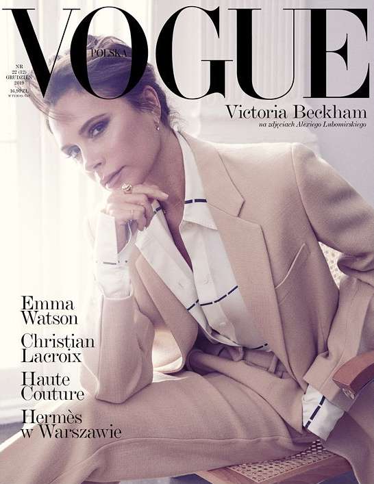 Vogue Polska cover featuring Victoria Beckham in a tan suit, seated indoors, with the magazine's logo and headlines visible. Fashion editorial.