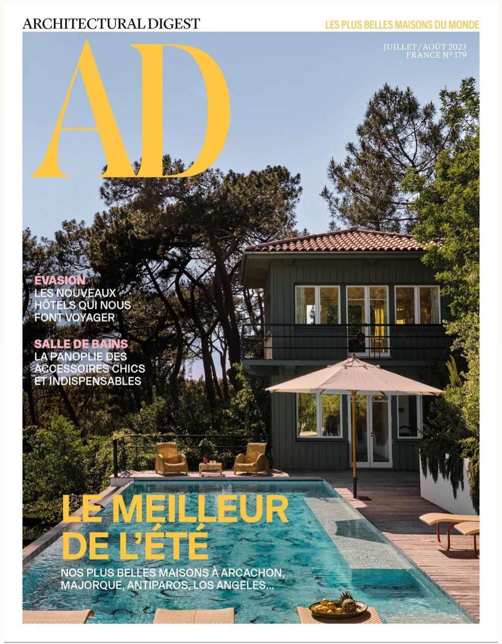 Architectural Digest cover featuring a modern house with a swimming pool surrounded by trees, promoting architecture and luxury design.