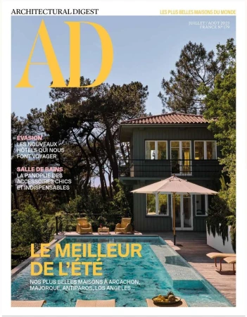 Architectural Digest cover featuring a modern house with a swimming pool surrounded by trees, promoting architecture and luxury design.