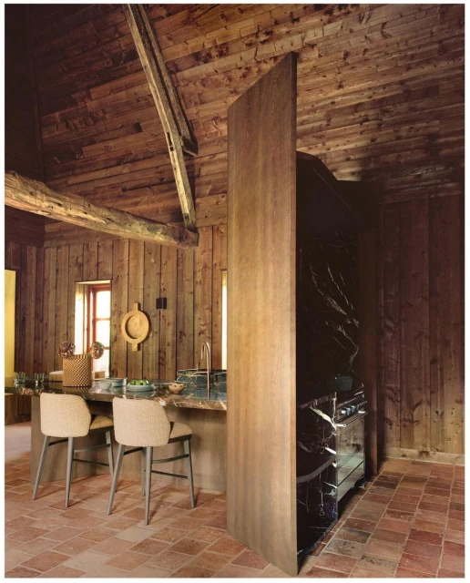 Rustic kitchen interior with wooden walls and ceiling, marble countertops, and stylish seating, creating a warm and inviting space.
