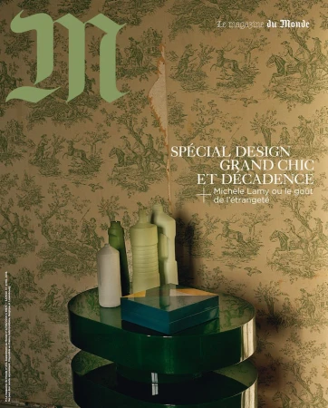 Magazine cover featuring decorative wallpaper backdrop, a round green table with sculptural objects and a rectangular box on top.
