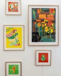 Framed colorful graphic illustration prints hanging on a clean white gallery wall by illustrator Alice Des.