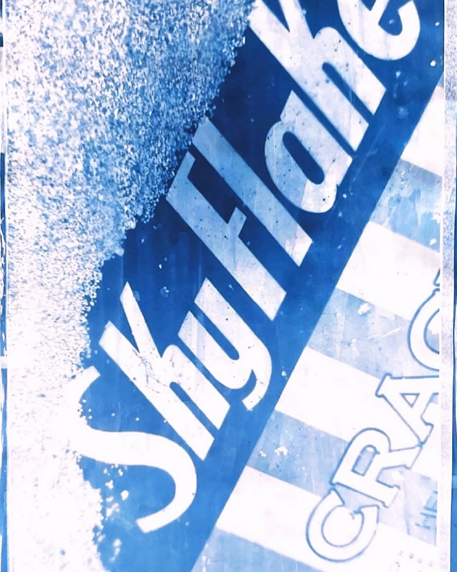 Close-up abstract photograph featuring blue and white typography and distressed textures by photographer Alice Rosati