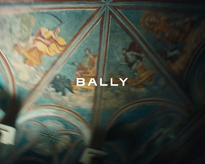 Painted ceiling with figures in yellow and white robes, and the BALLY brand name displayed in front of the artwork.