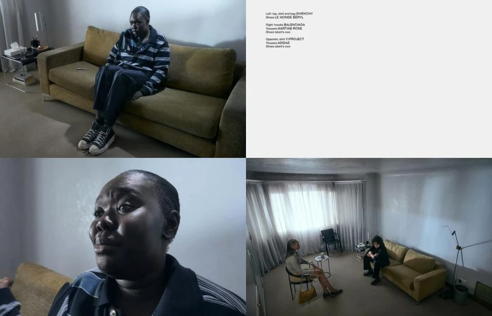An adult sits on a couch in a sparsely decorated interior, shot with subdued lighting in a melancholic fashion editorial style.