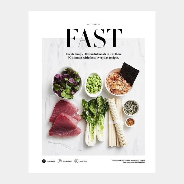 Overhead shot of fresh tuna, bok choy, edamame, seaweed and noodles on white surface promoting healthy and fast everyday recipes.