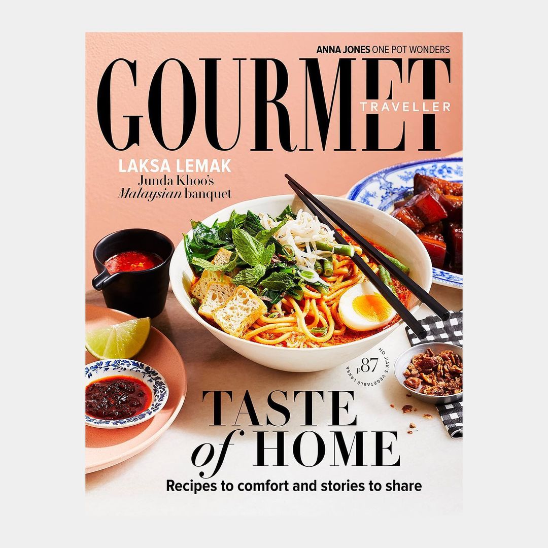 Gourmet Traveller magazine cover featuring laksa lemak, a Malaysian dish with noodles, tofu, egg, and greens, beside a small bowl of sauce.