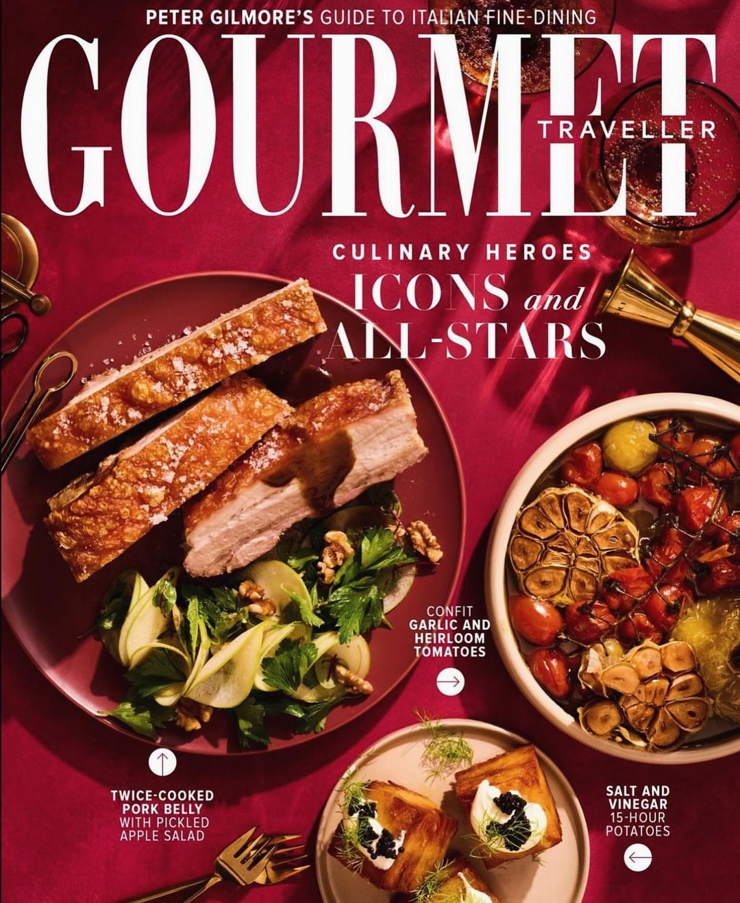 Magazine cover featuring gourmet food dishes including pork belly with apple salad and salt and vinegar potatoes on a red backdrop.