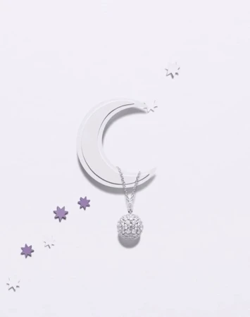 Elegant pendant necklace with a sparkling round diamond and set on a white surface with moon and star accents for luxury jewelry advertising.
