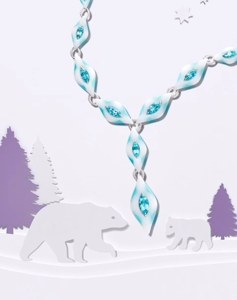 Stylish necklace with blue and white stones displayed against a wintery paper landscape with polar bears and snow-covered fir trees.