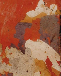 Close-up abstract photograph of weathered chipped red, orange, and purple paint on a textured concrete wall by Aliocha Boi in Paris.