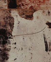 Textured abstract surface featuring distressed white plaster, dark brush marks, and a weathered brick background.
