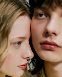 Close-up portrait of two young models with their heads pressed together photographed by Alizee Omaly
