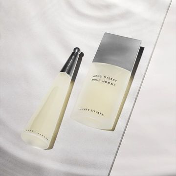 Issey Miyake L'Eau d'Issey Pour Homme fragrance bottles in a studio shot against a white backdrop with soft lighting and shadows.