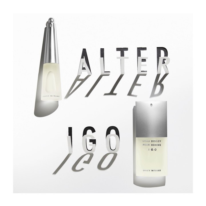 Still-life shot of two Issey Miyake L'Eau d'Issey Pour Homme IGO fragrance bottles against a white background with dimensional lettering.