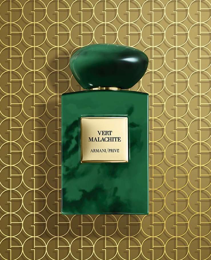 Vert Malachite Armani Prive perfume bottle on a gold geometric patterned background with green and gold color palette in studio shot.