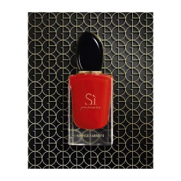 A rectangular red perfume bottle with a black cap centered against a repeating gold and black circular patterned background.