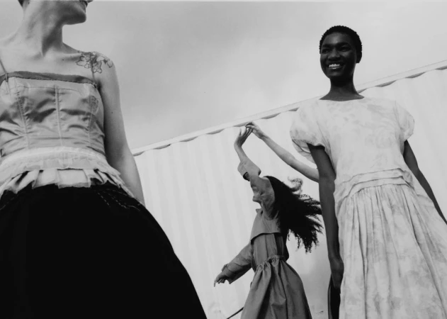 Black and white low angle fashion photography featuring three models outdoors by Allyssa Heuze.