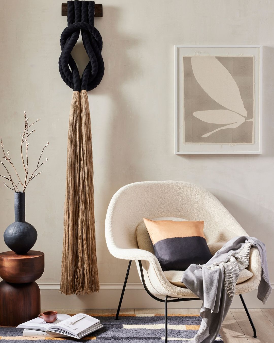 Interior design features a modern chair, wall art, and decorative rope art, creating a stylish and inviting indoor space.