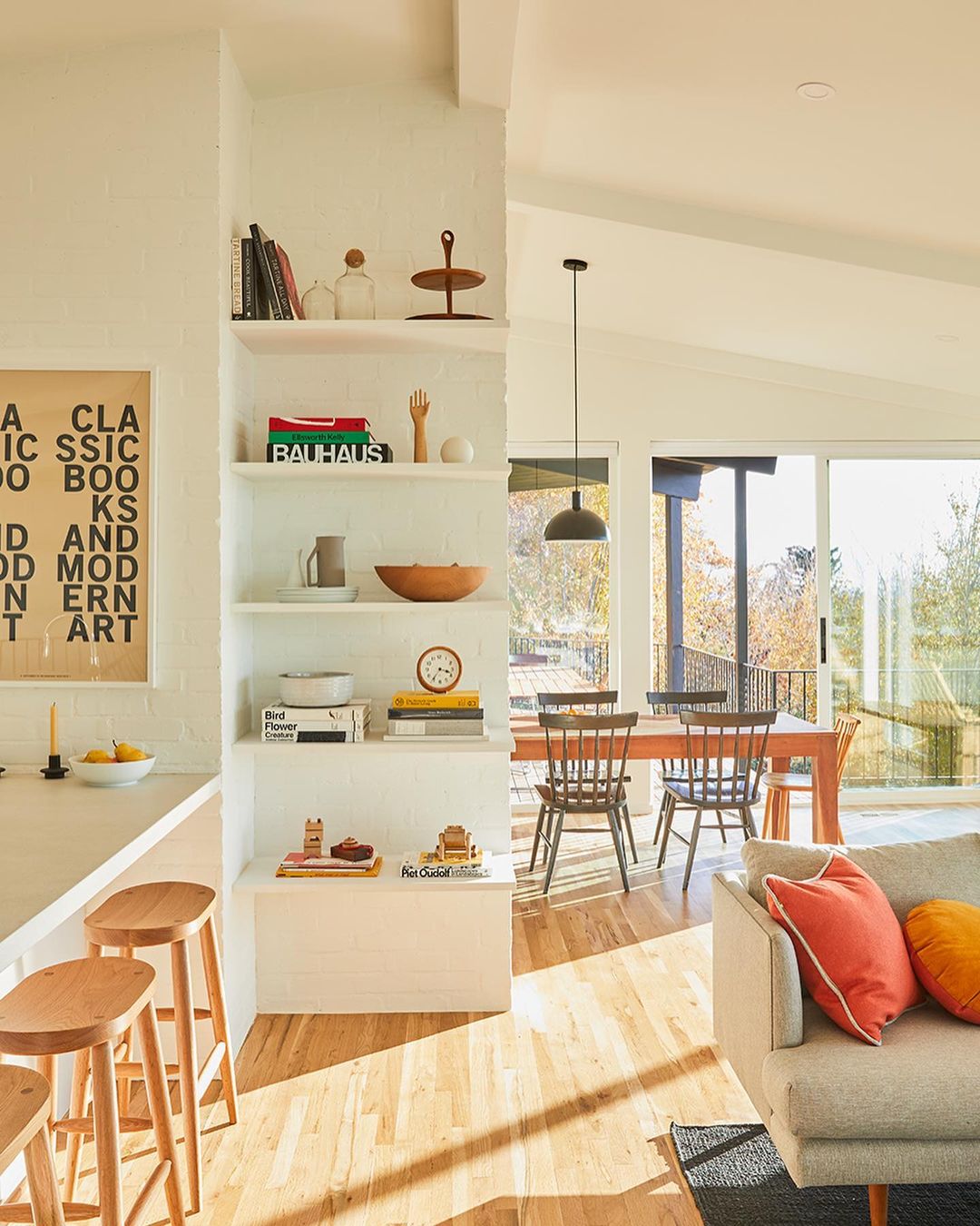 Bright and airy home interior with a modern aesthetic featuring light wood floors, comfortable seating, and minimalist decor.