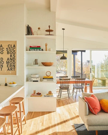 Bright and airy home interior with a modern aesthetic featuring light wood floors, comfortable seating, and minimalist decor.