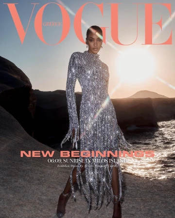 Vogue Greece cover featuring model Jourdan Dunn in a shimmering gown on Milos Island at sunrise, embodying 'New Beginnings.'