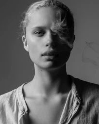 Monochrome portrait of a woman in a light top with wisps of smoke drifting across her face by photographer Amanda Demme