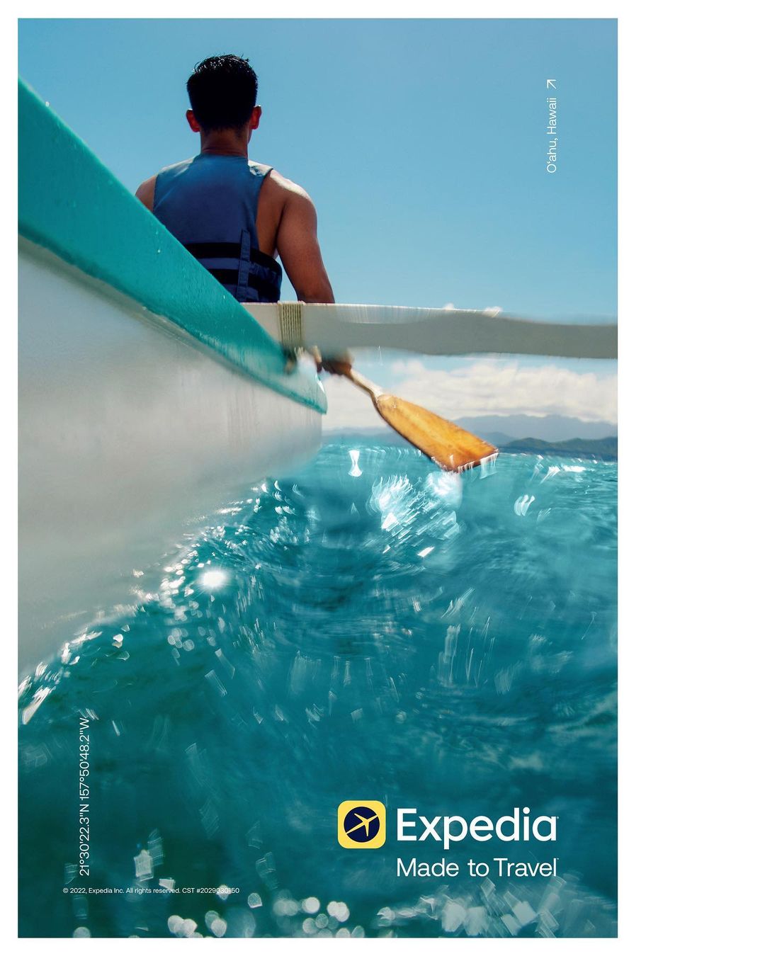 Man in a boat wearing a life vest paddles across clear, turquoise ocean waters under a clear blue sky. Expedia logo visible.