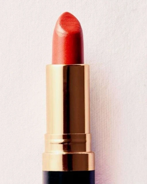 Close-up studio shot of red lipstick with gold tube and black base on a cream fabric background for beauty, fashion, and cosmetic use.