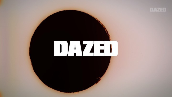Abstract background with a large, dark circular shape in the center, featuring the white 'DAZED' text logo, set against a gradient backdrop.